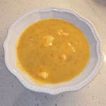 Creamy shrimp chowder with potatoes in a white bowl