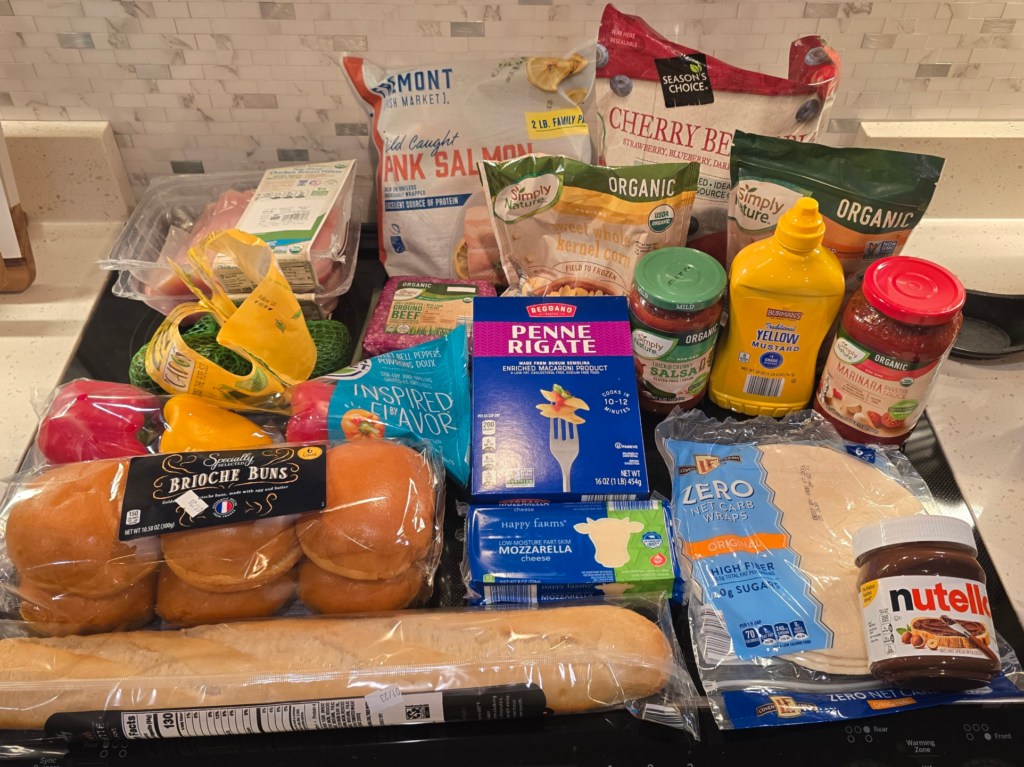 Aldi grocery haul with organic thin sliced chicken breasts, grass fed beef, wild caught salmon value pack, and fresh produce