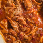Slow cooker salsa chicken in pot with jar of organic salsa - easy meal prep